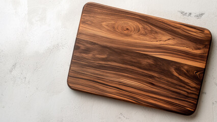 Fototapeta premium A wooden cutting board with a natural grain pattern, placed on a light background, perfect for food preparation or kitchen decor.