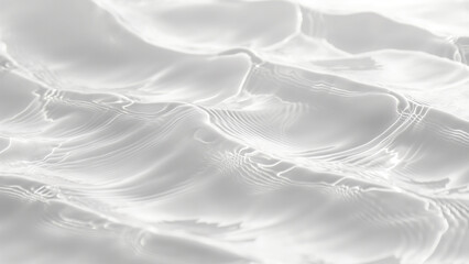 Obraz premium Close-up of light ripples on clear water surface, creating a soft, abstract texture in grayscale.