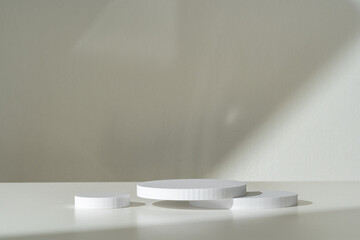 Modern Minimalist White Sculpture Displayed on Soft Draped Fabric in Natural Light