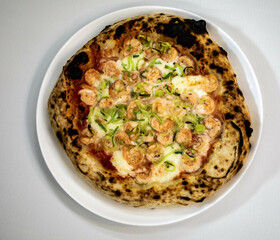 Rustic artisanal shrimp pizza with catupiry cheese and leeks