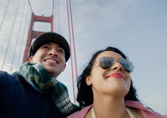 Young couple walking through the Golden Gate Bridge in San Francisco, California.