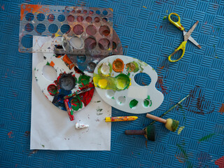 Children and adults make shapes and sculptures with play dough and draw pictures.