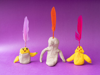 Children and adults make shapes and sculptures with play dough and draw pictures.