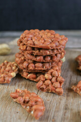 Thai Fried Peanut Cookies on dark background. Deep Fried Bean cookies peanut crackers made from nuts and flour to fry.