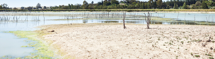 Environment, empty dam and outdoor with drought, natural disaster and climate change crisis on banner. Landscape, countryside and dry lake with eco emergency, global warming or la nina in Portugal