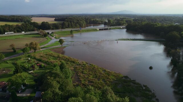 Katy Wroclawskie, Lower Silesia, Poland - September 19 2024: Aerial view of rising rivers threaten southern Poland near Wroclaw, A4 Autostrada Highway, Bystzryca river floods roads and villages