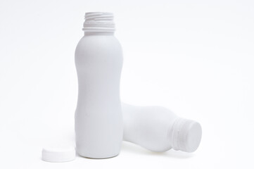 White plastic bottle with cap on a white background.