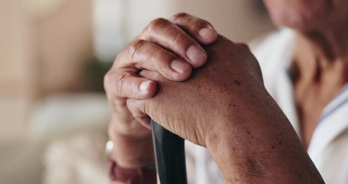 Senior, hands and support on walking stick for balance in retirement with recovery or rehabilitation. Elderly, person with disability or cane for alzheimers in nursing home with healthcare assistance