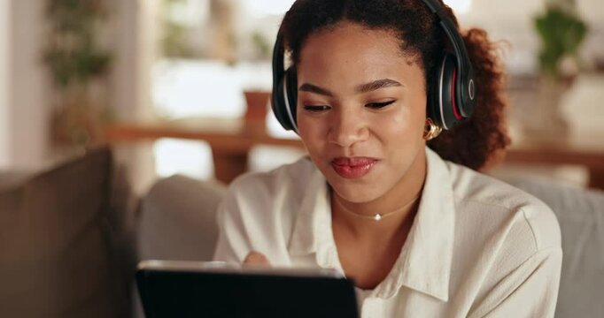 Headphones, relax and woman with tablet in home listening to music, podcast or playlist for blog review. App, happy and female freelance critic on sofa with audio tech for streaming album at house.