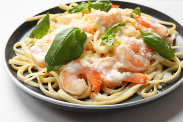 Tasty pasta with shrimps on white table, closeup