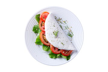 tapioca or beiju with vegetables, tomato, arugula, in white plate isolated on white background