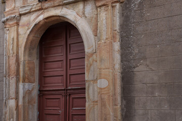 Discover and explore the stunning architectural beauty of this historic entrance, showcasing striking red doors