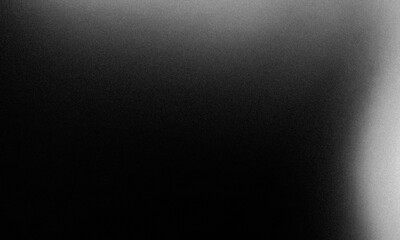 A dark, grainy image with a subtle gradient from black to a lighter gray.