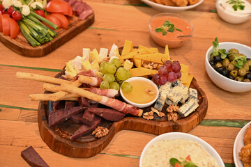 Plate with grapes, smoked meat and cheese with mold, Romania 2024, Romania 2024