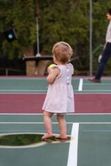 playing pickleball with a baby girl