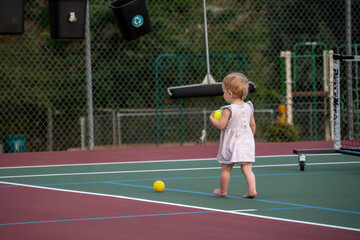 playing pickleball with a baby girl
