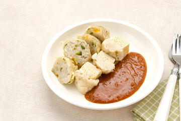 Siomay Bandung (Shumay) or steamed dumplings with boiled tofu. Indonesian traditional street food with peanut sauce.
