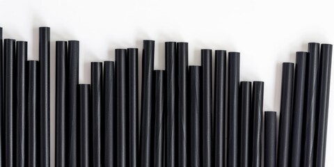 Obraz premium Sustainable Dark Paper Straws Set Against a Light Backdrop