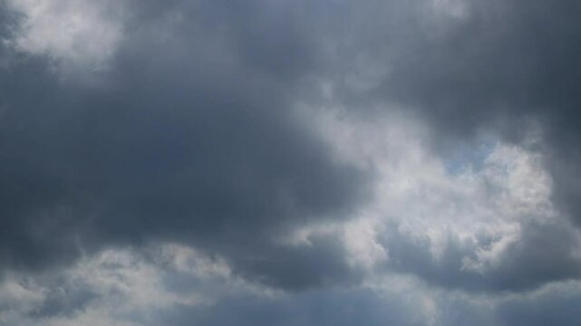 The rapid and dramatic movement of black clouds covers the daytime sky. Time lapse footage of black clouds. 4K,60Fps available