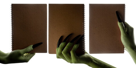 Set of witches hands holding notebooks for copy space. The hand color is green. Evil, zombie, or monster hand