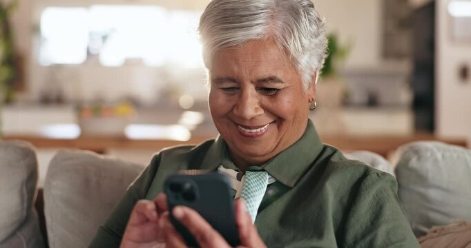 Senior woman, phone and smile on sofa, texting and reading with mobile app for contact in home. Person, smartphone and scroll with chat, notification and social network on lounge couch in retirement