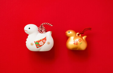 Japanese new year material. Zodiac Snake. Snakes ornament on the red background. 日本のお正月素材。干支の巳（ヘビ）。赤背景上の巳の置物