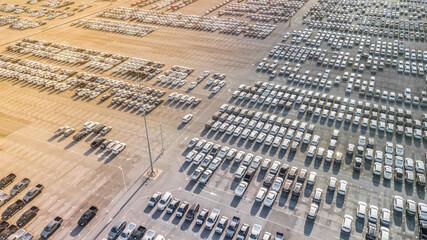 Aerial view new cars lined up in the port for import and export, Top view of new cars lined up automobile factory global logistic import export, New cars logistic to dealership for sale.
