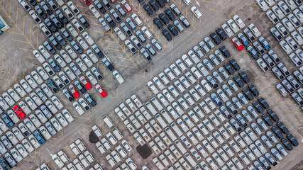 Aerial view new cars lined up in the port for import and export, Top view of new cars lined up automobile factory global logistic import export, New cars logistic to dealership for sale.