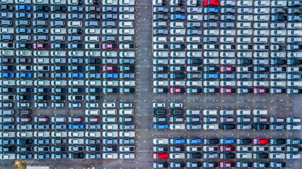 Aerial view new cars lined up in the port for import and export, Top view of new cars lined up automobile factory global logistic import export, New cars logistic to dealership for sale.