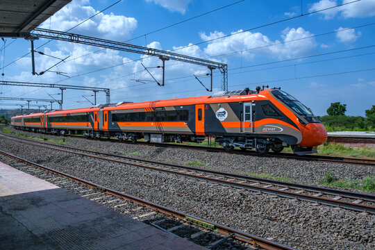 Pune, India - September 18 2024: Saffron coloured Vande Bharat Express near Pune India. This is a tri-weekly train between Pune and Kolhapur and also a tri-weekly train between Pune and Hubballi.