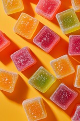 Gummy candy fruit on orange background 