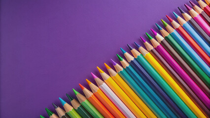 Vibrant multicolored pencils arranged in a creative pattern on a rich purple background, offering ample space for text or design elements to be added.
