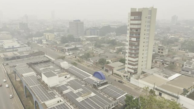 Drone orbits to the right over the top of Justi&ccedil;a Federal em Rond&ocirc;nia on smokey afternoon due to wildfires in Porto Velho, Rond&ocirc;nia, Brazil