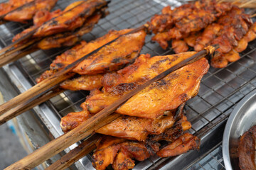Grilled skewers chicken on the tray. Traders at the beach in Thailand. Very popular foods in Thailand.