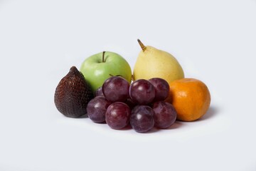 Assortment of exotic fruits isolated on white background. Close up of heap of fruit. Concept of healthy eating and dieting lifestyle. 