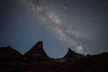 the Milky Way in the starry sky against the background of the Parabola mountain in Ergaki