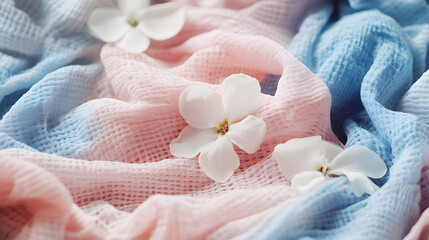 pile of freshly laundered clothes, soft and fluffy, with delicate flower petals scattered around