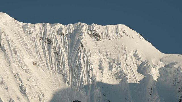 Snowy Winter Himalayas Mountain Ridge in Nepal, Close Up Snowcapped Mountains Covered in Snow with Blue Sky while Terkking and Hiking in Nepal on Annapurna Circuit