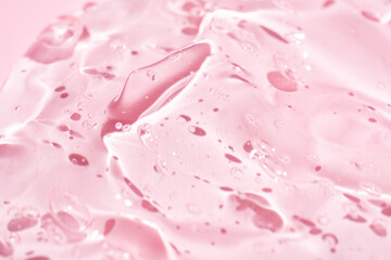 Close-up image displaying a pink pure gel texture with glossy highlights and clear droplets, ideal for background use