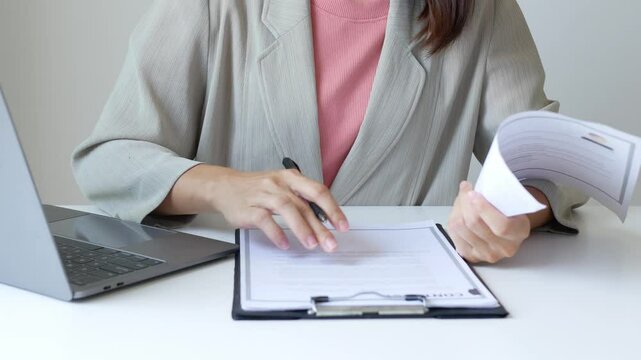 Business woman employer holds resume and talks with job applicant for job interview about her career and personal history in company, recruitment concept.

