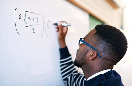 Teaching, classroom and black man writing on whiteboard for math lesson, learning and examination. Education, university and teacher write equation for knowledge, assignment and studying in college