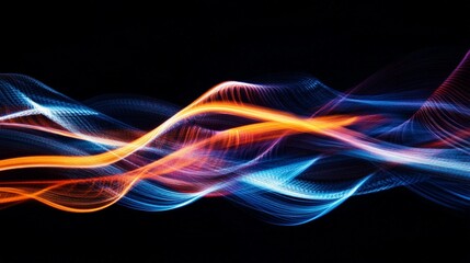 Fototapeta premium Vibrant light trails forming swirling patterns against a black backdrop, creating a dynamic effect.