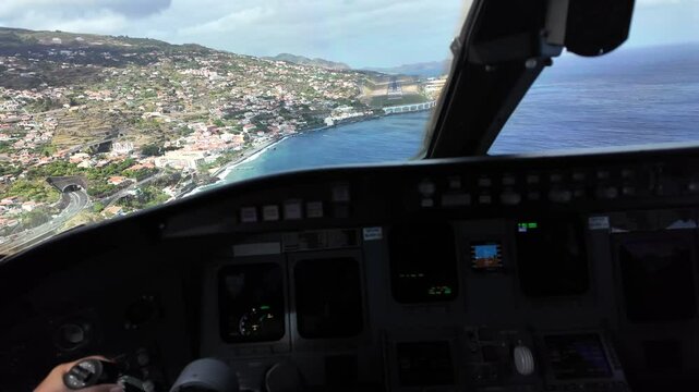 Immersive pilot&rsquo;s view in a real tima landing at dangerous Funchal Madeira airport in a windy day with turbulence. Daylight with some clouds in the sky. 4K 60FPS