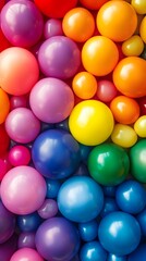 Colorful rainbow of balloons in the background, with vibrant colors.