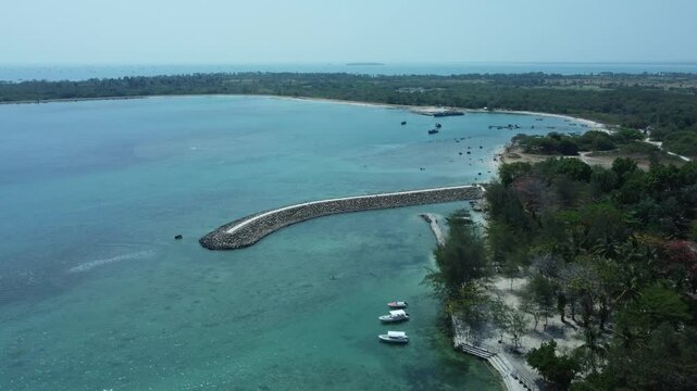 Aerial photo of Tanjung Lesung beach resort landmark, with blue sky and beautiful blue sea. Aerial drone of La Lassa Beach Club during the day.