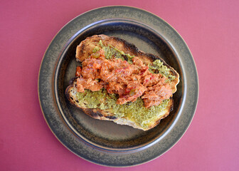 A tuna and bean mix with BBQ sauce on toasted cob bread with basil pesto.