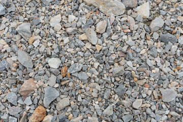 Rough textured background showing a variety of small crushed gravel rocks