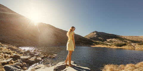 Woman In Yellow Dress Enjoying Mountain Lake Scenery