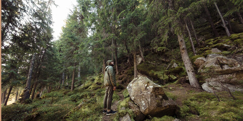 Man Hiking in Dense Forest: Adventure and Nature Exploration