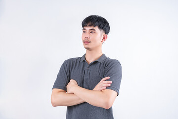 Portrait of handsome Asian man with arms crossed. Concept of stability and confidence in career and business on white background.